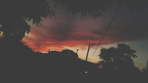 Low angle view of silhouette trees against sky during sunset