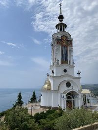 Church by building against sky