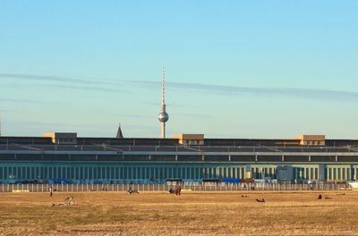 View of buildings in city against clear sky