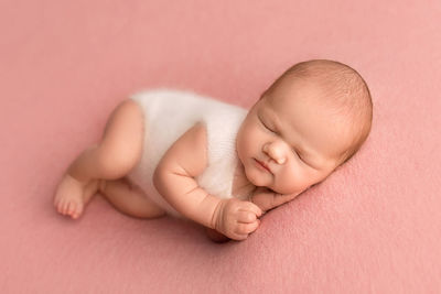 Close-up of baby on bed