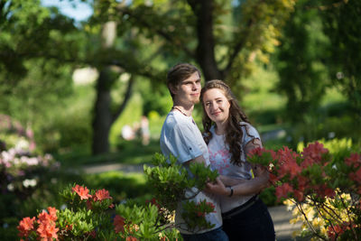 Portrait of couple smiling while standing at park