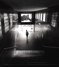 Full length of woman walking in tunnel