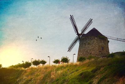 Low angle view of windmill against sky