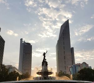 Modern sculpture in city against sky