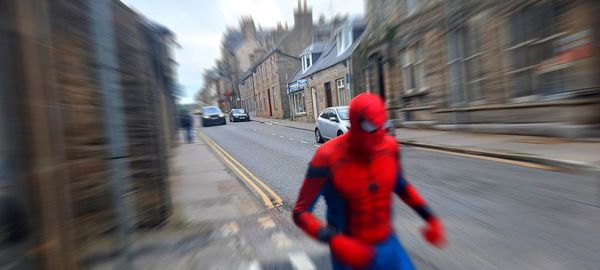 Blurred motion of man walking on street in city