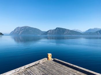 Scenic view of lake against clear blue sky