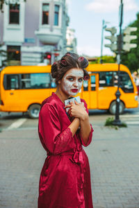 Young woman standing on street in city
