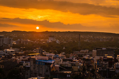 Dramatic sunset orange sky with city view from mountain top at evening