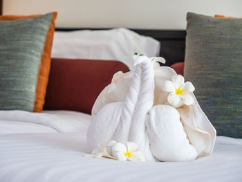 Bird made of towels on bed in hotel room