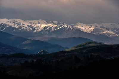 Scenic view of mountains against sky at night