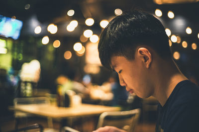 Portrait of young man sitting in restaurant