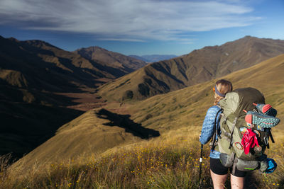 People on mountain against sky