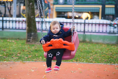 Young woman playing in playground at park