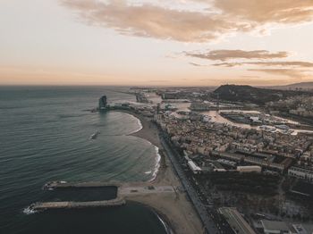 Aerial view of barcelona, spain with harbor and skyline at beautiful sunset with ocean view