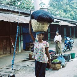 Full length of a boy standing in front of built structure