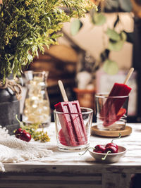 Homemade ice popsicles in transparant glass on the table. country stilllife concept