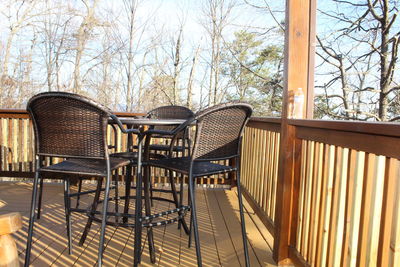 Empty chairs and table against trees