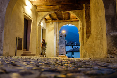 Surface level of woman standing at corridor of historic building