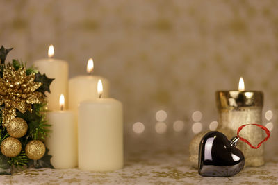 Close-up of christmas decorations with candles on table