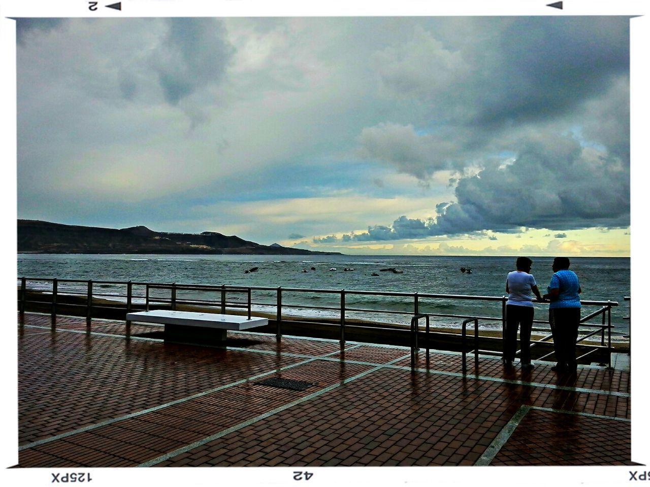 transfer print, sky, cloud - sky, water, lifestyles, auto post production filter, leisure activity, sea, full length, men, cloudy, standing, railing, rear view, cloud, person, weather