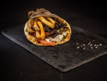 High angle view of pizza on table against black background