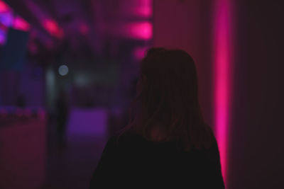 Silhouette of woman at illuminated room night