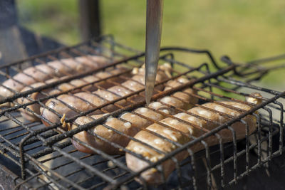 Chicken sausages on the grill. cooking at the stake. close-up.