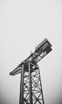 Low angle view of crane against clear sky