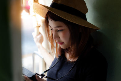 Close-up of young woman wearing hat