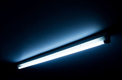 Low angle view of illuminated lights in dark room