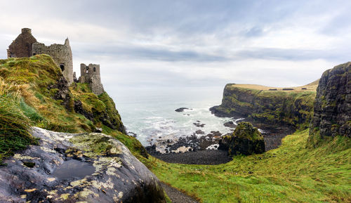 Rock formations by sea against sky