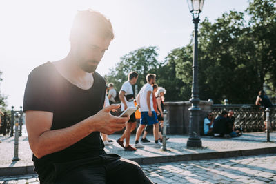 Group of people using mobile phone against clear sky