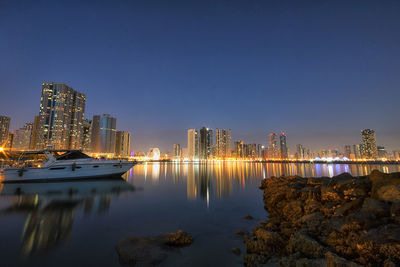 View of illuminated cityscape against clear sky