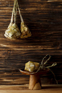 Ketupat lebaran, mandatory dishes on of eid al-fitr celebration. on rustic wooden table