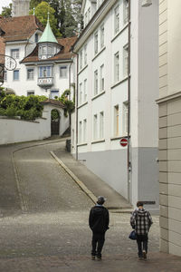 Rear view of people walking on street