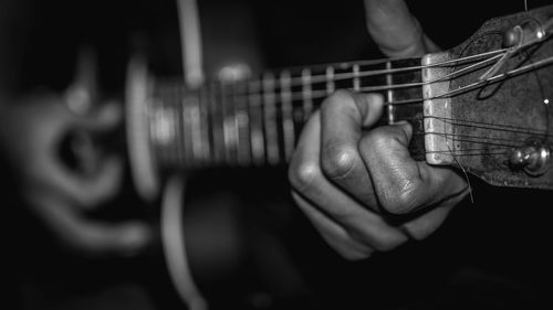 Close-up of hands playing guitar