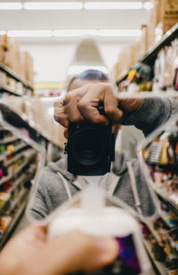 Creative selfie in mirror while shopping.