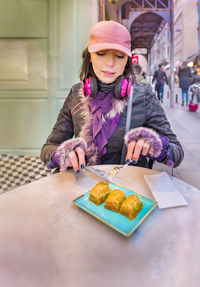 Woman eating food at table