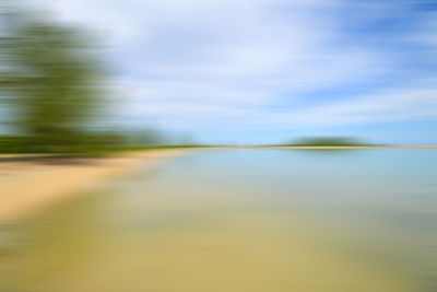 Blurred motion of lake against sky
