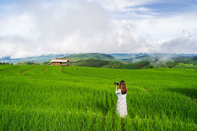 Rear view of man looking at farm