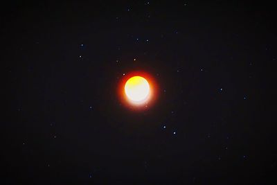 Low angle view of moon against sky at night