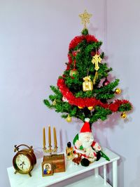 Decorated christmas tree on table at home