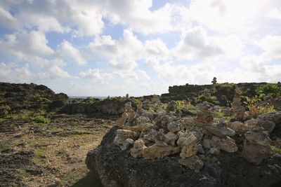 Panoramic shot of rocks on field against sky