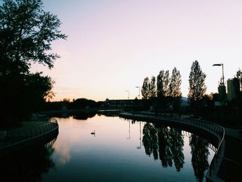 Scenic view of lake against clear sky during sunset