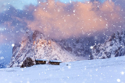 Scenic view of snow covered field against mountains