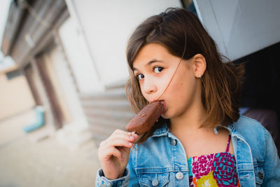 Portrait of girl eating ice cream outdoors
