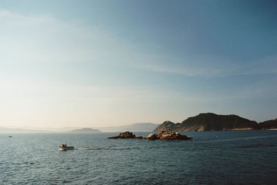 Scenic view of boat in sea against sky