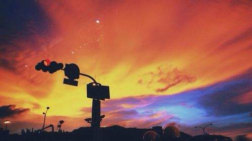 Silhouette of building against dramatic sky