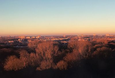 Aerial view of cityscape against sky during sunset