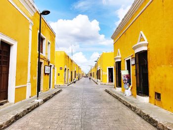 Yellow residential buildings against sky